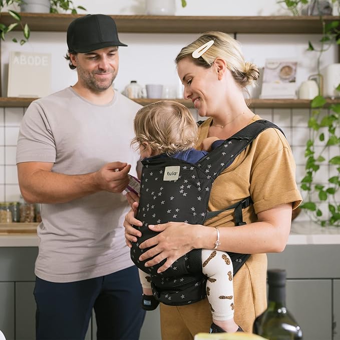 Baby Tula Lite Ripstop Nylon Compact Baby Carrier, Lightweight & Ergonomic Carrier for Travel w/Convenient Storage Hip Pouch, Multiple Carrying Positions for 12lbs to 30lbs - Discover (Black/Stars)