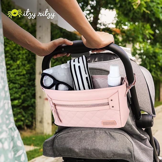 Itzy Ritzy Adjustable Stroller Caddy/Organizer - Stroller Organizer Bag Featuring Front Zippered Pocket, 2 Built-in Interior Pockets & Adjustable Straps to Fit Nearly Any Stroller (Blush)
