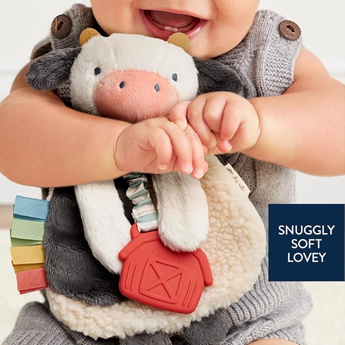 Itzy Ritzy - Itzy Lovey Including Teether - Baby Lovey with Teether, Textured Ribbons & Dangle Arms - Features Crinkle Sound, Sherpa Fabric and Minky Plush (Cow)